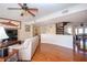 Living room featuring hardwood floors, spiral staircase, and a fireplace at 443 Pinellas Bayway S # 105, Tierra Verde, FL 33715