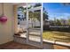 Screened patio with door leading to grassy backyard at 443 Pinellas Bayway S # 105, Tierra Verde, FL 33715