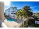 Community pool with lounge chairs and palm trees at 443 Pinellas Bayway S # 105, Tierra Verde, FL 33715