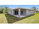 Single-story home with covered patio and grassy yard at 5127 Tower St, North Port, FL 34291