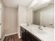 Bathroom with double vanity, large mirror, and neutral color palette at 5127 Tower St, North Port, FL 34291