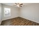Spacious bedroom with ceiling fan and wood-look flooring at 5127 Tower St, North Port, FL 34291