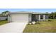 Gray house with white garage door and landscaping at 5127 Tower St, North Port, FL 34291