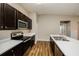 Modern kitchen with dark cabinets and stainless steel appliances at 5127 Tower St, North Port, FL 34291