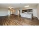 Open concept living room with kitchen view and hardwood floors at 5127 Tower St, North Port, FL 34291