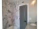 Modern bathroom with marble-look shower walls and a gray vanity at 5198 40Th S St, St Petersburg, FL 33711