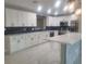 Updated kitchen boasting white cabinets, stylish backsplash, and a large island at 5198 40Th S St, St Petersburg, FL 33711