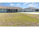 Spacious backyard with large grassy area and patio at 7061 Denmark St, Englewood, FL 34224