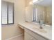 Bathroom with single sink vanity and large mirror at 7061 Denmark St, Englewood, FL 34224