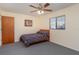 Small bedroom with double bed, ceiling fan, and double door closet at 7061 Denmark St, Englewood, FL 34224