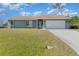 Single story home with attached garage and lawn at 7061 Denmark St, Englewood, FL 34224