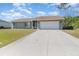 Single story home with attached garage and lawn at 7061 Denmark St, Englewood, FL 34224