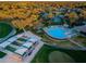 Aerial view of community pool, shuffleboard, and golf course at 7065 Sparkling Creek Ct, Spring Hill, FL 34606