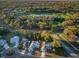 Aerial view showcasing the neighborhood golf course, mature trees and manicured lawns at 7065 Sparkling Creek Ct, Spring Hill, FL 34606