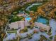 Overhead view showing the neighborhood clubhouse, pool, tennis courts and parking lot at 7065 Sparkling Creek Ct, Spring Hill, FL 34606