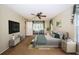 Comfortable bedroom with large window, ceiling fan, and access to a patio at 7065 Sparkling Creek Ct, Spring Hill, FL 34606