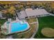 Aerial view of the clubhouse and pool with lounge chairs for community residents at 7065 Sparkling Creek Ct, Spring Hill, FL 34606