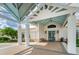 Elegant entrance to a community center with a covered walkway and blue doors at 7065 Sparkling Creek Ct, Spring Hill, FL 34606