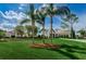 Exterior view of a community clubhouse with palm trees and lush landscaping at 7065 Sparkling Creek Ct, Spring Hill, FL 34606