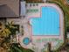Aerial view of the community swimming pool and hot tub with sunning area at 7065 Sparkling Creek Ct, Spring Hill, FL 34606