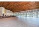 Large community room with wood floors and wood ceilings at 7065 Sparkling Creek Ct, Spring Hill, FL 34606