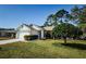 Charming single-story home with well-maintained lawn and mature landscaping at 7065 Sparkling Creek Ct, Spring Hill, FL 34606