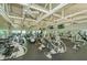 Spacious gym equipped with various exercise machines, TV screens, and ample workout space at 7065 Sparkling Creek Ct, Spring Hill, FL 34606