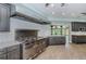 Modern chef's kitchen featuring stainless steel appliances, large island and white subway tile backsplash at 7065 Sparkling Creek Ct, Spring Hill, FL 34606
