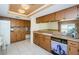 Full kitchen with tile floors, granite countertops and sink at 7065 Sparkling Creek Ct, Spring Hill, FL 34606