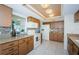 Bright kitchen features granite countertops, updated appliances, and wood cabinets at 7065 Sparkling Creek Ct, Spring Hill, FL 34606