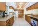 Full kitchen with tile floors, granite countertops and bright lighting at 7065 Sparkling Creek Ct, Spring Hill, FL 34606
