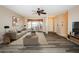 Cozy living room featuring modern furnishings, hardwood floors, and lots of natural light at 7065 Sparkling Creek Ct, Spring Hill, FL 34606