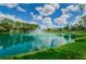 Scenic pond with a fountain surrounded by lush greenery and walking paths in a community at 7065 Sparkling Creek Ct, Spring Hill, FL 34606