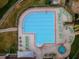 Aerial view of a community pool and spa area with many lounge chairs available at 7065 Sparkling Creek Ct, Spring Hill, FL 34606
