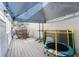 Back patio with deck, trampoline, and covered seating area at 764 Captiva Ne Ct, St Petersburg, FL 33702