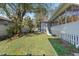 Large grassy backyard with mature tree and fenced perimeter at 764 Captiva Ne Ct, St Petersburg, FL 33702