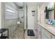 Updated bathroom with a walk-in shower and pebble floor at 764 Captiva Ne Ct, St Petersburg, FL 33702