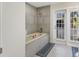 Bathroom with soaking tub and access to private outdoor space at 764 Captiva Ne Ct, St Petersburg, FL 33702