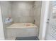 Bathroom with soaking tub and gray tile surround at 764 Captiva Ne Ct, St Petersburg, FL 33702