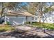 Single-story home with a gray garage door and a neat lawn at 764 Captiva Ne Ct, St Petersburg, FL 33702
