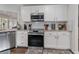 Kitchen with white cabinets, granite counters, and stainless steel appliances at 764 Captiva Ne Ct, St Petersburg, FL 33702