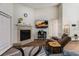 Living room with a corner fireplace and large TV at 764 Captiva Ne Ct, St Petersburg, FL 33702