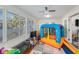 Bright sunroom with plenty of windows, a play area, and comfortable seating at 764 Captiva Ne Ct, St Petersburg, FL 33702