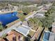 Aerial view of a house near a lake with a pool in the neighborhood at 7736 Chadwick Dr, New Port Richey, FL 34654