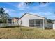 Backyard with screened patio and fence at 7736 Chadwick Dr, New Port Richey, FL 34654