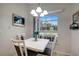 Small dining area with white table and four chairs near window at 7736 Chadwick Dr, New Port Richey, FL 34654