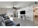 Living room features tiled floors, ceiling fan, and sliding glass doors at 7736 Chadwick Dr, New Port Richey, FL 34654