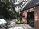 Brick patio with walkway, lush landscaping, and exterior access at 807 Grove Park Ave, Tampa, FL 33609