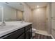 Bathroom with dark brown vanity, double sinks, and a large shower at 849 Haleybury St, Port Charlotte, FL 33948