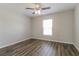 Simple bedroom with wood-look flooring and a window at 849 Haleybury St, Port Charlotte, FL 33948
